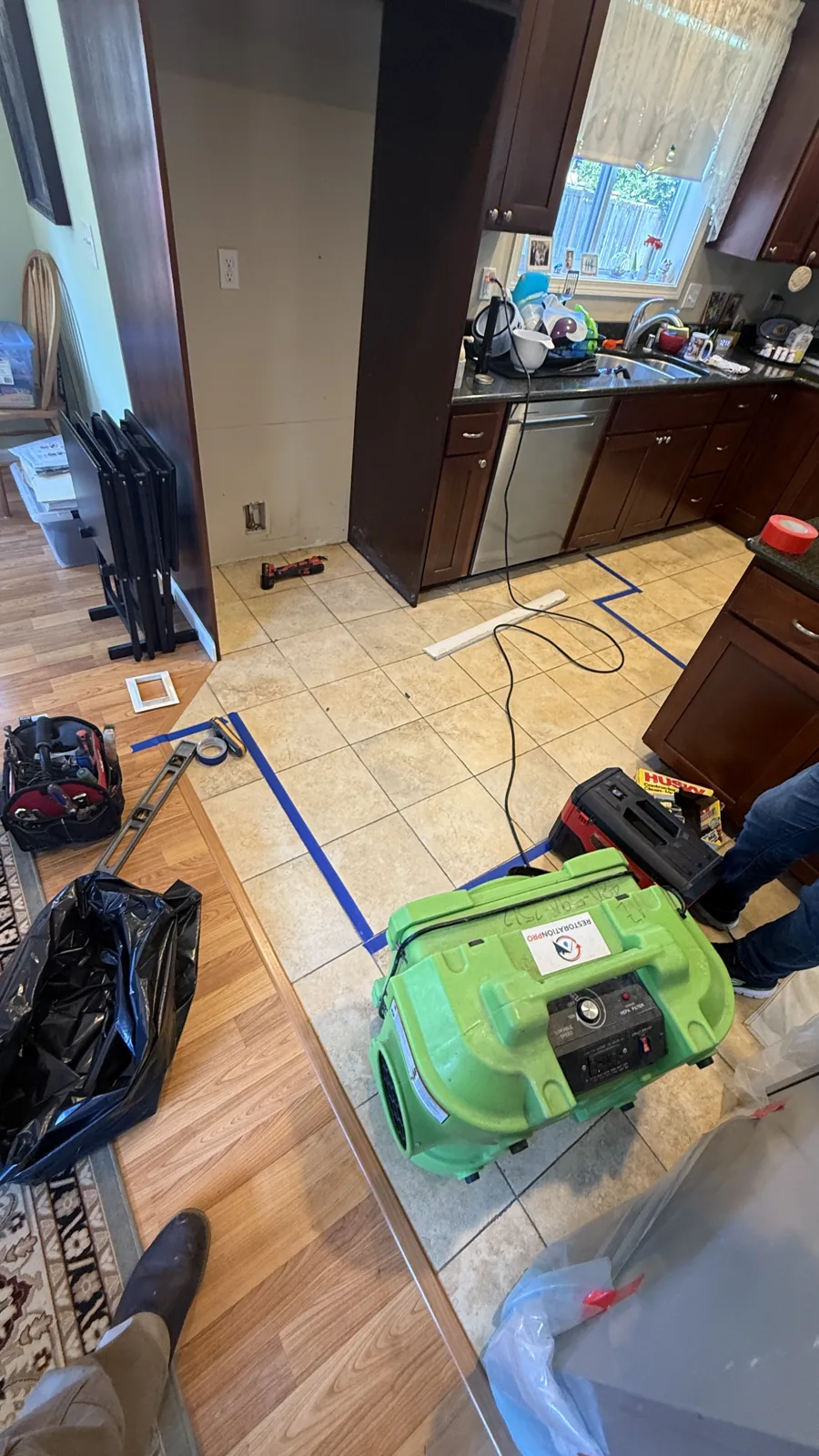 Edmonds: Floor drying equipment placed near the refrigerator after the kitchen leak.