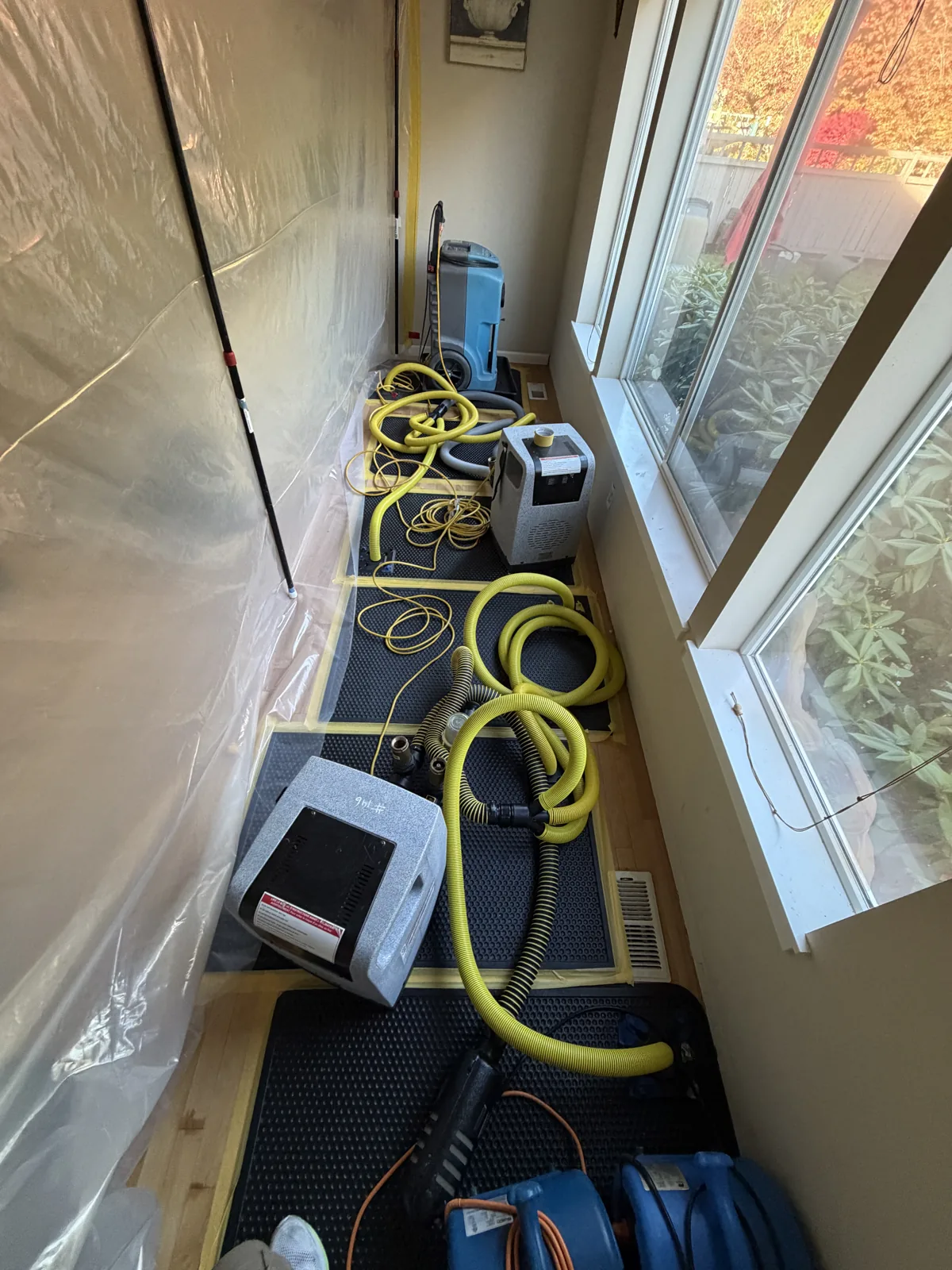 Issaquah: Connected drying mats treating the living room floor near the exterior wall.