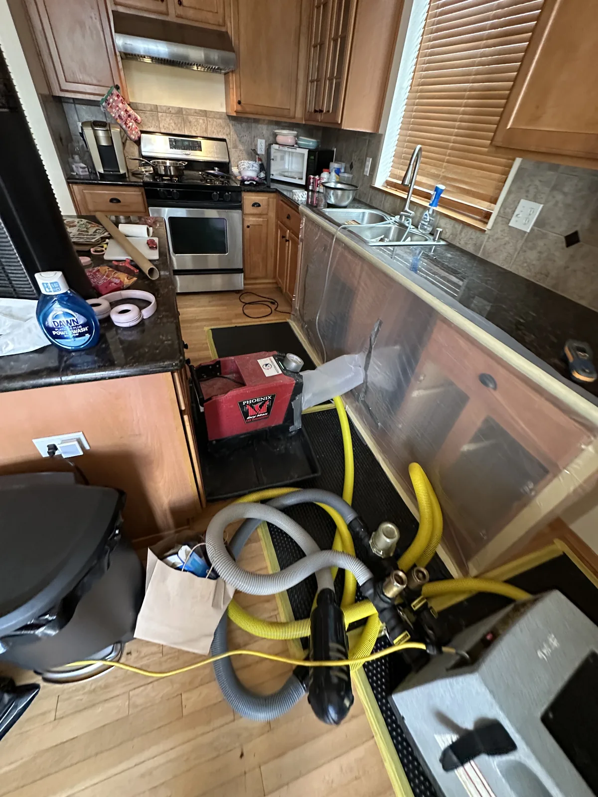 Kenmore: Connected mats and drying equipment treating the affected hardwood.