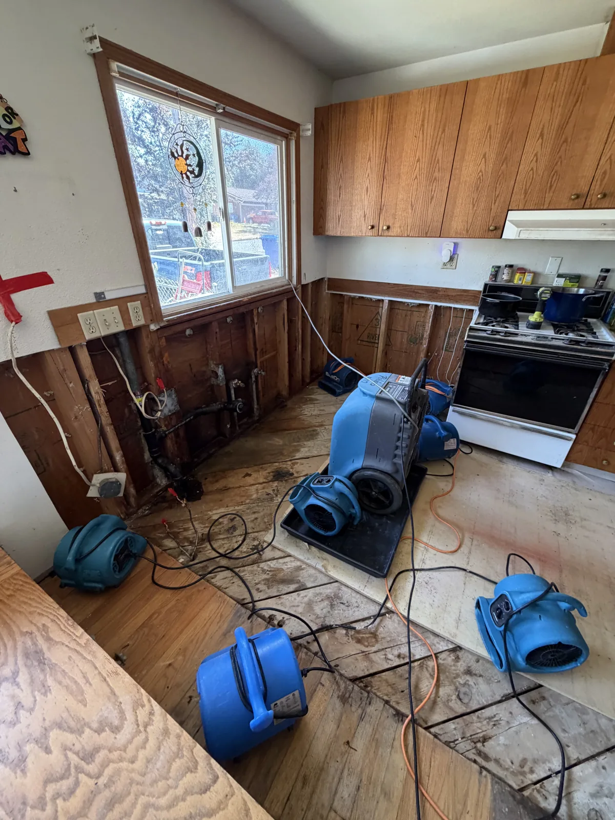 Kent: Air movers and a dehumidifier treating the opened kitchen work area.