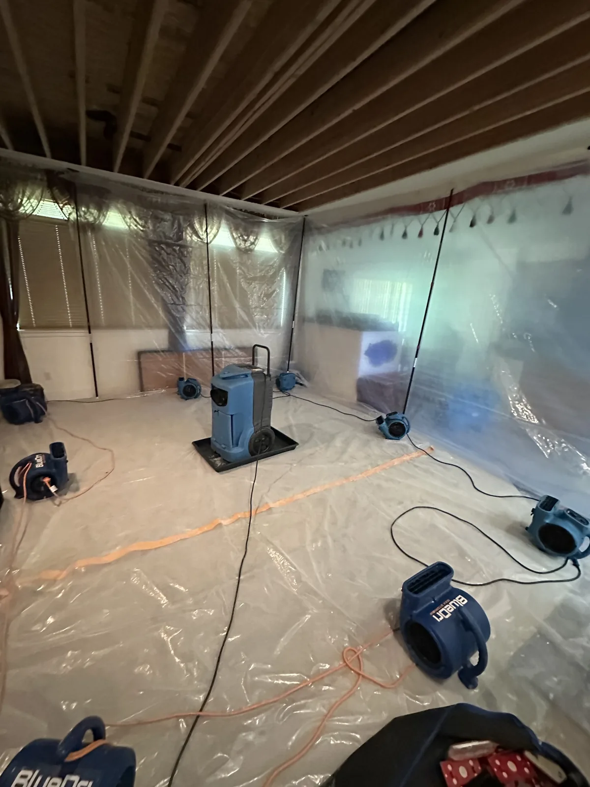 Lynnwood: Exposed ceiling framing with containment and drying equipment in place.