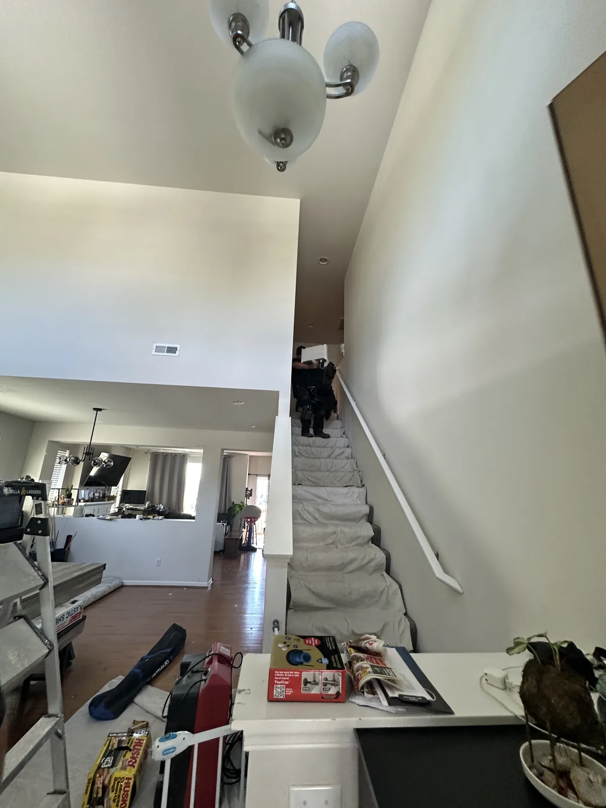 Mercer Island: The ceiling opening below the upstairs bathroom, with nearby floor protection.