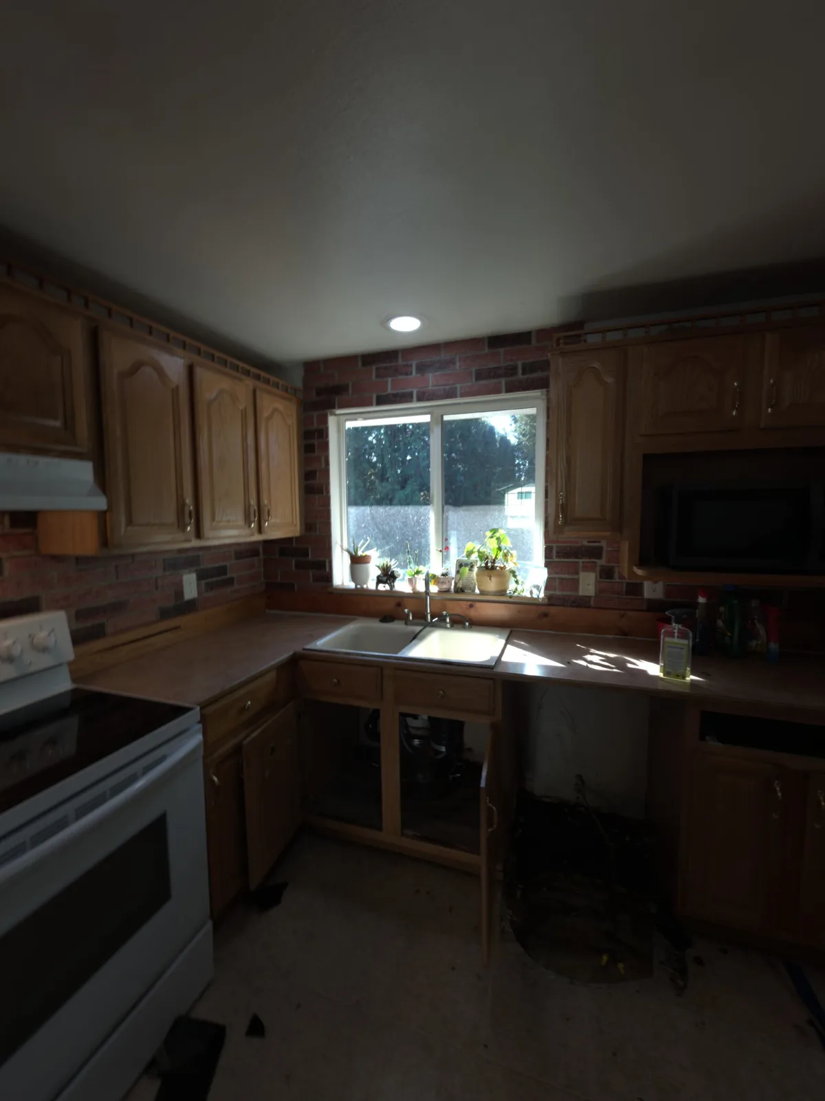 Renton: Affected lower cabinets and flooring removed to expose the kitchen work area for drying.