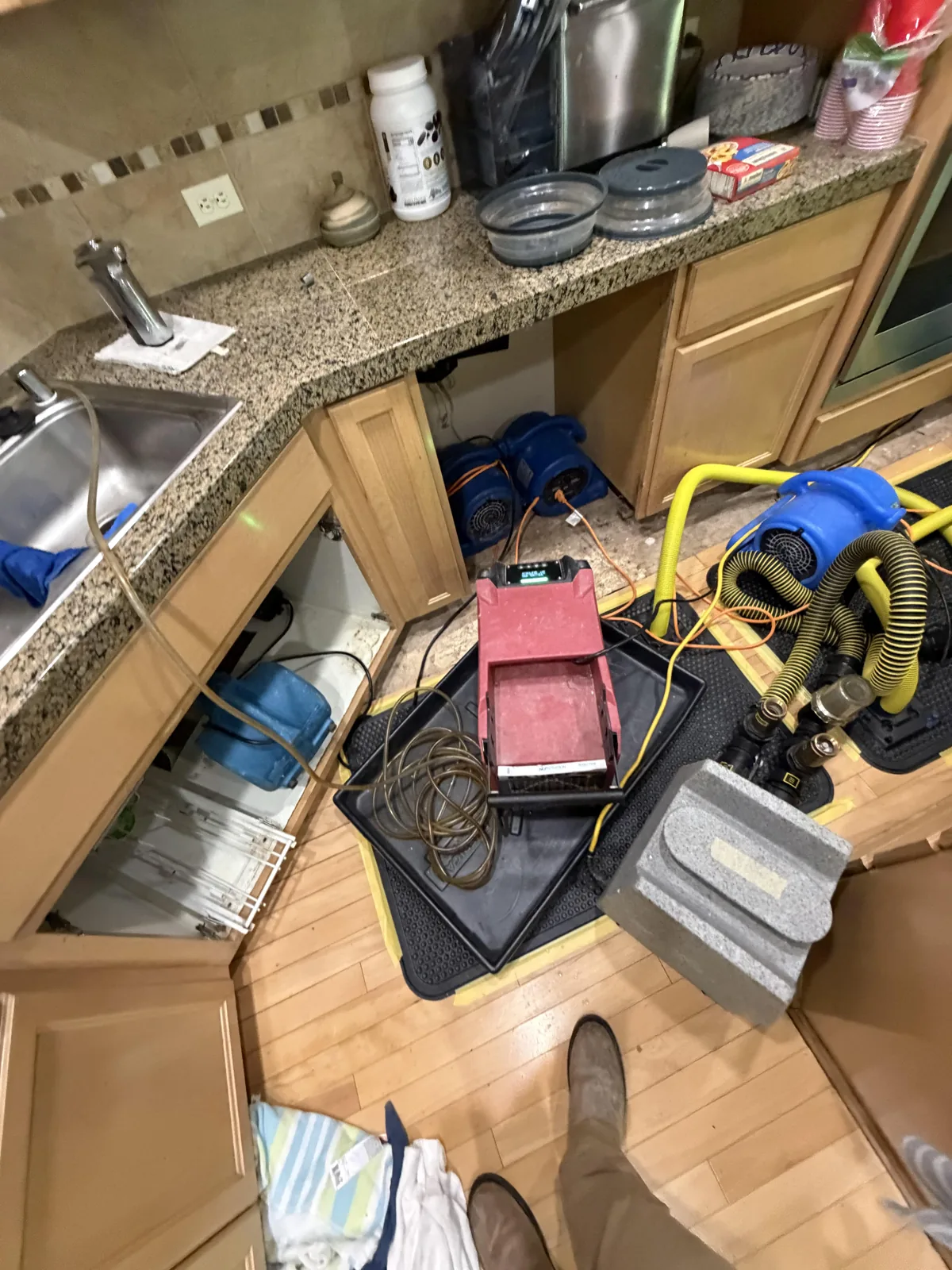 Sammamish: Targeted flooring removal and drying equipment beside the dishwasher opening.