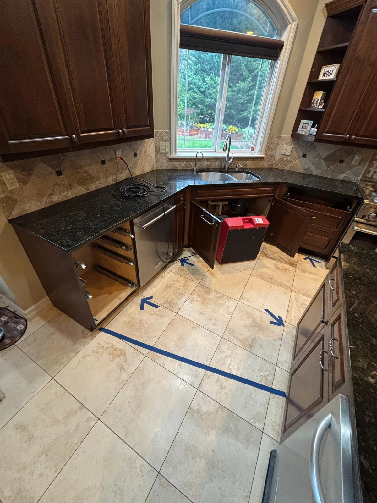 Seahurst: Lower cabinets removed to access the wall affected by the concealed pipe leak.